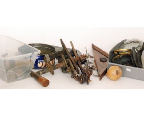A collection of brass barrel and cast pine cone regulator clock weights, also various turned wood finials, mouldings, dial ba