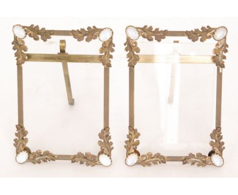 A pair of gilt metal rectangular easel photograph frames, each with applied oak leaf decoration and opal style cabochons to t