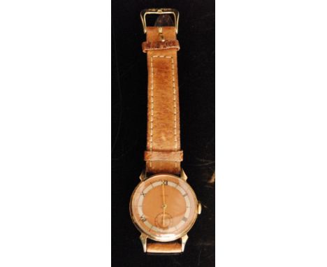 A 1940s 9ct Smiths Astral gentleman's manual wrist watch, the two tone rose gold circular dial, silvered chapter ring with Ar