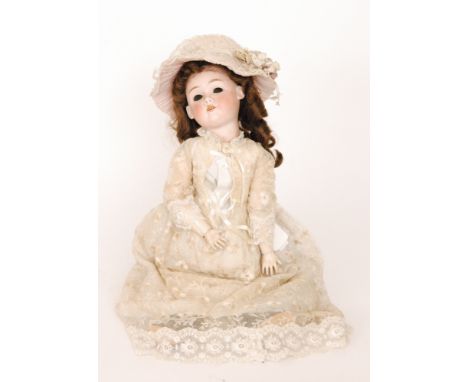 A Max Handwerck German bisque head doll with open close eyes and mouth and jointed composition body wearing a lace embroidere