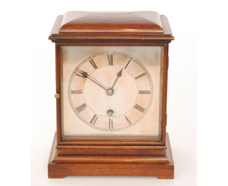 A 20th Century mahogany cased mantle clock with silvered dial and chapter ring on bracket plinth base, height 20cm