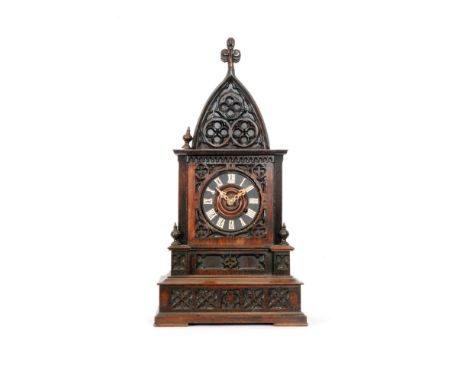 A 19th Century carved oak Black Forest cuckoo mantle clock, in a dome shaped Gothic style case with stepped plinth base, heig