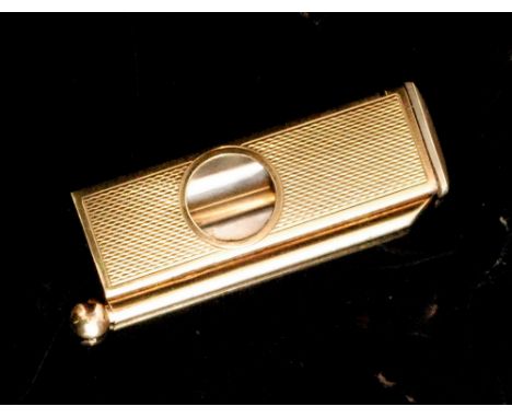 A 9ct hallmarked rectangular shaped cigar cutter with engine turned decoration and conforming cigar piercer to one side, leng