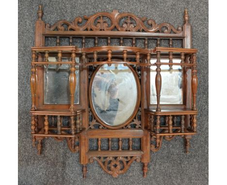 An Anglo Indian hardwood bracket shelf, with acanthus leaf friezes, spindle galleries and three mirror panels, height 70cm an