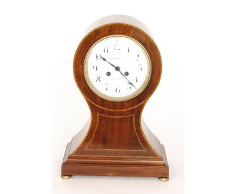 An Edwardian inlaid mahogany balloon cased mantle clock with an eight day movement striking on a gong, the dial signed 'Finni
