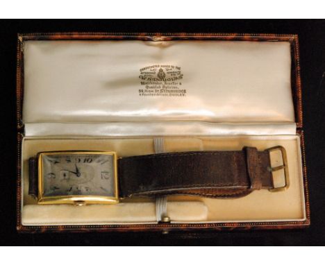 An Art Deco 9ct Swiss gentleman's manual wind wrist watch, of shaped rectangular outline with silvered dial and black Arabic 