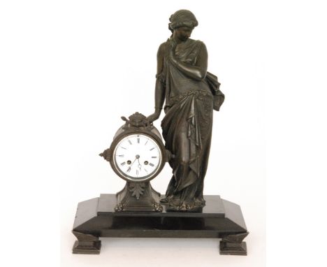 A 19th Century French spelter figural mantle clock with an eight day movement, Roman numerals to a white enamelled circular d