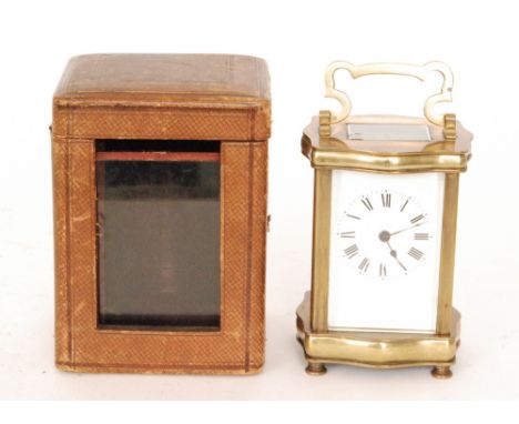 A late 19th Century French brass carriage clock in cartouche case with bevelled glass panels and white enamelled dial, height