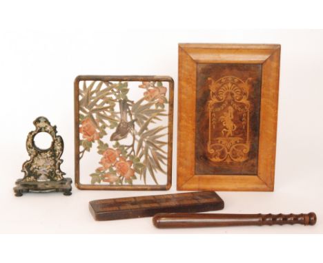 A 19th Century marquetry inlaid walnut panel of a dancing cherub with a tamborine, a carved Japanese of a finch amidst pale f
