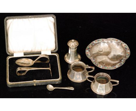 A hallmarked silver feeding spoon and pusher set, cased, a three piece condiment set with spoon, various dates and makers and