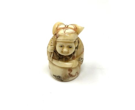 A carved Chinese bone netsuke - Figure holding a sack on back