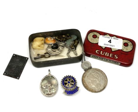 A small Oxo tin containing silver mounted pendant, silver Rotary Hexham badge, coin, costume jewellery