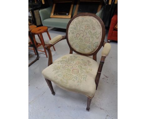 An antique continental armchair upholstered in a floral tapestry fabric  