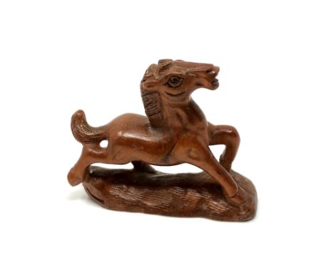 A carved Chinese hardwood netsuke - Cantering foal