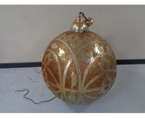 A spherical white metal embossed light fitting 