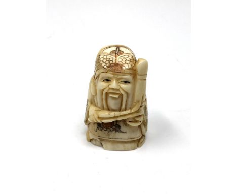 A carved Chinese bone netsuke - Gentleman holding a club