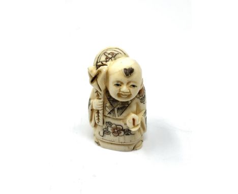 A carved Chinese bone netsuke - Gentleman with sack and fruit