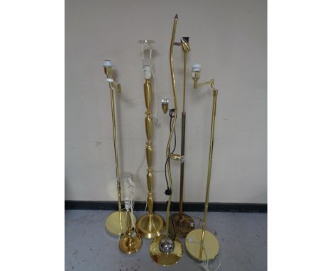 Five brass floor lamps together with a brass table lamp (continental wiring)  