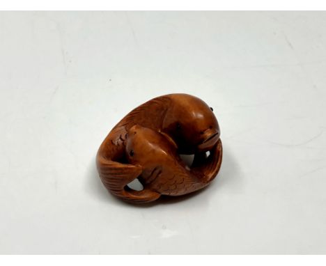 A carved Chinese hardwood netsuke - Two carp