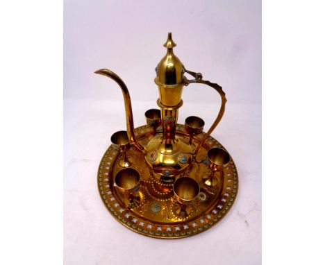 An Eastern brass eight piece serving set comprising of teapot, six goblets and tray  