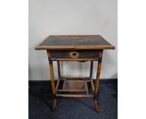 A ceramic elephant plant stand together with an early 20th century bamboo two tier occasional table, fitted a drawer  