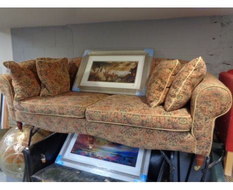 A Victorian style low backed settee in tapestry fabric with six cushions 