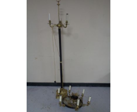 A continental brass and metal three way floor lamp together with a similar six way chandelier 