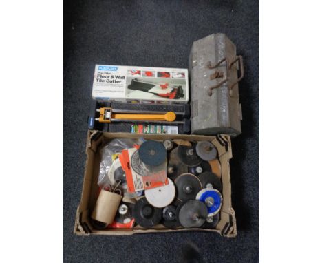 A box of circular drill disks together with a heavy duty metal toolbox and two tile cutters 