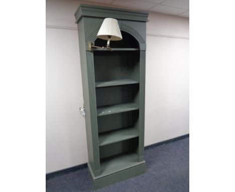 A set of painted contemporary open bookshelves fitted with a lamp 