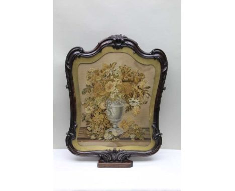 A Victorian tapestry panel, depicting a floral display, glazed and framed, fashioned as a firescreen, 79cm tall