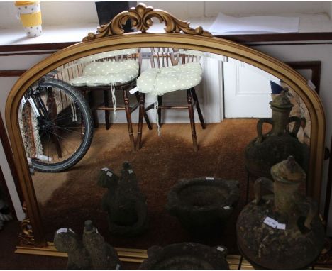 A modern gilt framed arch top bevel plate over mantel mirror