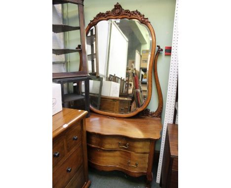 A very large probable Continental mahogany dressing table, with fancy shaped bevelled plate mirror, supported by a low three 