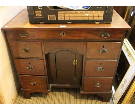 A 19th century mahogany kneehole desk, single full width drawer over concealed central drawer, over locked central cupboard (