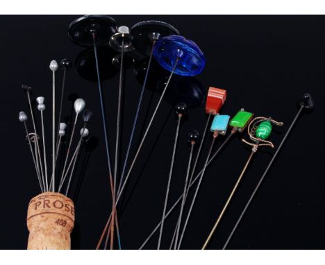 A collection of hat-pins, to include; one silver example, hardstone topped and enamel topped examples 