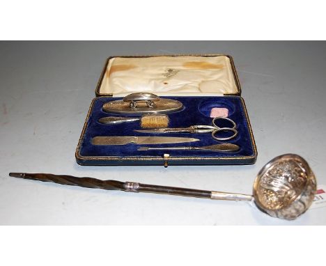 A boxed silver manicure set (lacking one object) together with a silver toddy ladle, two silver teaspoons and an Indian white