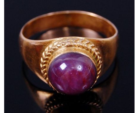 A yellow metal (unmarked but tests as approx 18ct) and cabochon ruby set ring, the ruby weighing approx 2.5ct, 6.6g, size Q/R