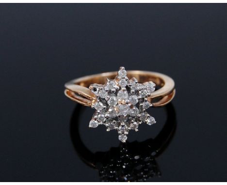 A modern 9ct gold cluster ring, the small brilliants in a snowflake setting (one stone missing), 2.9g, size K- 