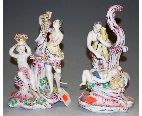 A pair of 19th century Continental glazed ceramic figure groups, each depicting a lady aside a child, in the classical taste,