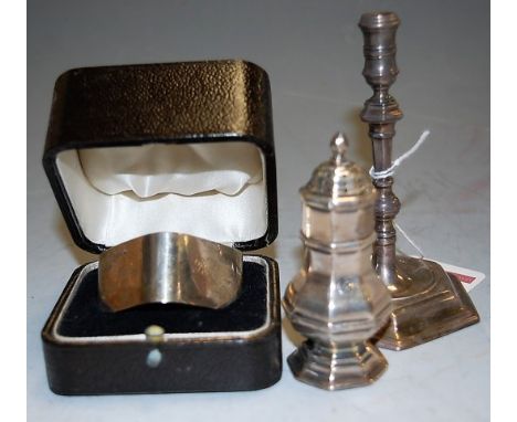 A 17th century style miniature silver candlestick on a hexagonal base, together with a miniature octagonal pepper, and a boxe