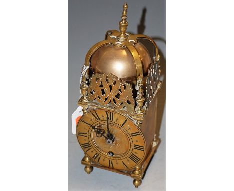 A reproduction brass lantern clock