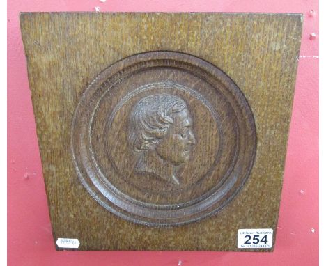 Carved oak panel of gentleman