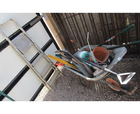 Wheelbarrow full of tools to include step ladders