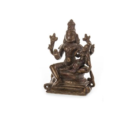 20TH CENTURY EASTERN BRONZE FIGURE OF A DEITY, modelled seated and holding a small figure, 10cm high