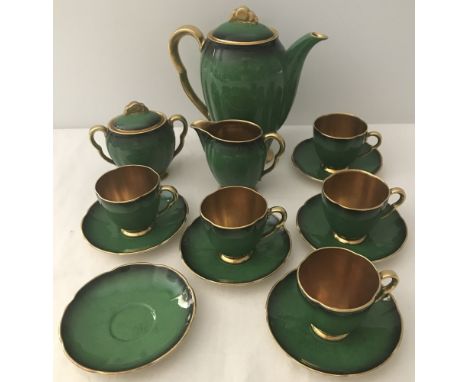 A Carlton Ware green & gilt part coffee set. Comprising:- Coffee pot, sugar bowl, milk jug, 5 coffee cups & 6 saucers 