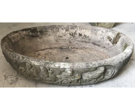 A large oval shaped concrete garden planter with decoration to sides.  Approx. 45cm x 68cm x 17cm tall.