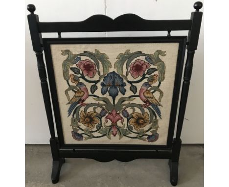 A vintage wooden framed tapestry fire screen with iris and bird decoration.  Approx 72 x 58cm.