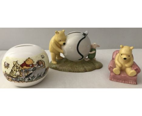 3 Royal Doulton Winnie the Pooh ceramic items. Comprising; a spherical christening money box, "Winnie the Pooh in the Armchai