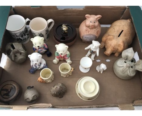 A box of assorted ceramics. To include vintage egg cups, money banks and crested china. 