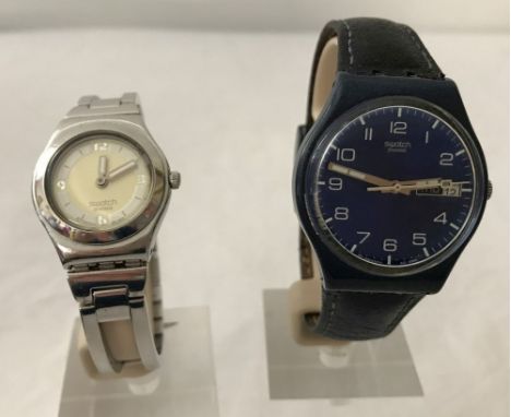 A blue dial leather strap Swatch watch together with a 2002 Irony stainless steel Swatch watch.  