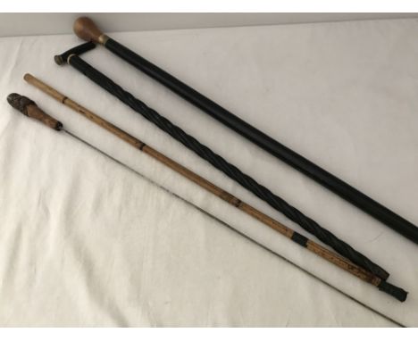 3 vintage walking sticks to include a bamboo sword stick. Together with a wooden handled walking stick with compass set into 